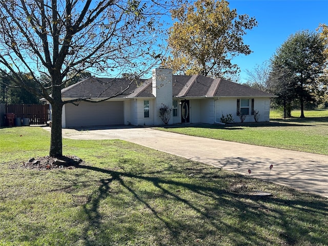 single story home with a front yard and a garage