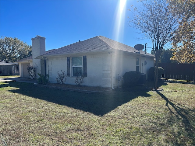 exterior space with a yard and a garage