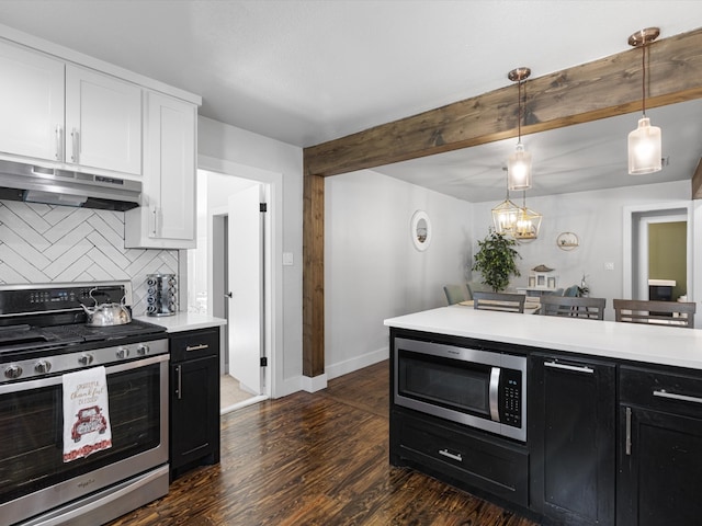 kitchen featuring appliances with stainless steel finishes, white cabinetry, hanging light fixtures, dark wood-type flooring, and beam ceiling