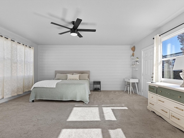 bedroom featuring light colored carpet and ceiling fan