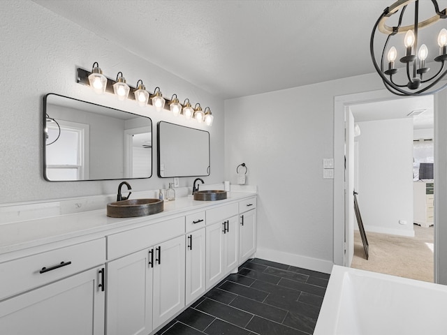 bathroom with vanity and a washtub