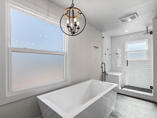 bathroom with a chandelier, independent shower and bath, and a textured ceiling