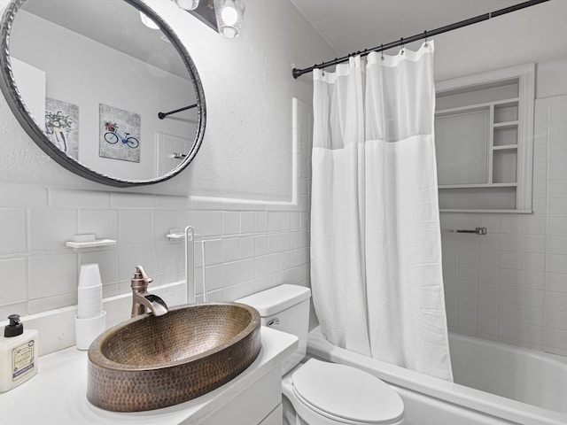 full bathroom with vanity, toilet, shower / bath combo with shower curtain, and tile walls