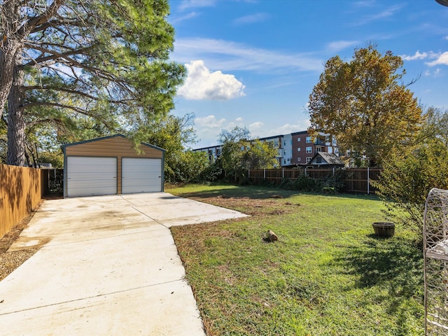 view of yard featuring an outbuilding and a garage