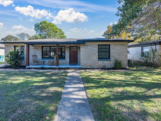 view of front of house with a front yard and a porch