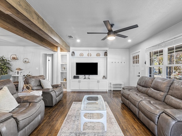 living room with ceiling fan, dark hardwood / wood-style floors, and a textured ceiling