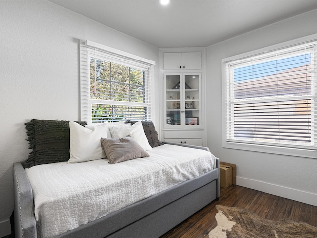 bedroom with dark wood-type flooring