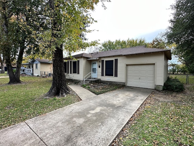 single story home featuring a garage and a front yard