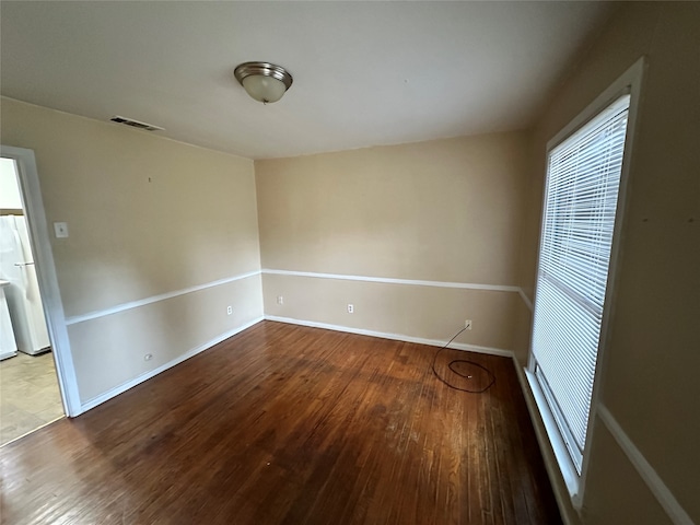 unfurnished room with hardwood / wood-style floors