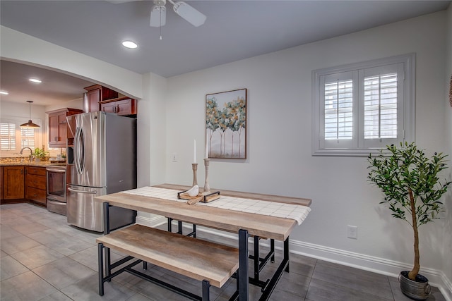 dining area with tile patterned floors, ceiling fan, and sink