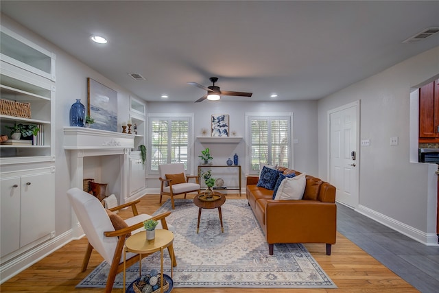 living room with ceiling fan and light wood-type flooring