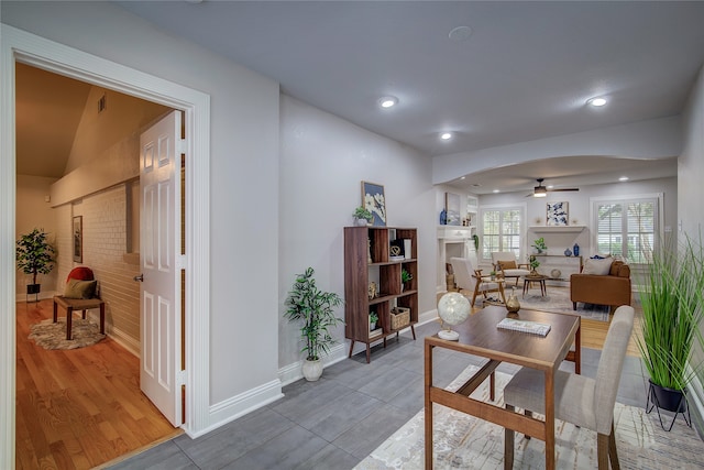 dining area featuring hardwood / wood-style floors, ceiling fan, and lofted ceiling