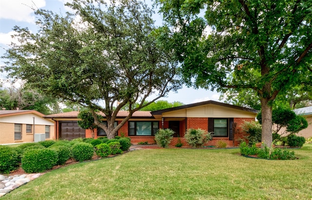 single story home with a front lawn and a garage