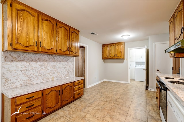 kitchen with light stone countertops, ventilation hood, backsplash, white appliances, and washer / dryer