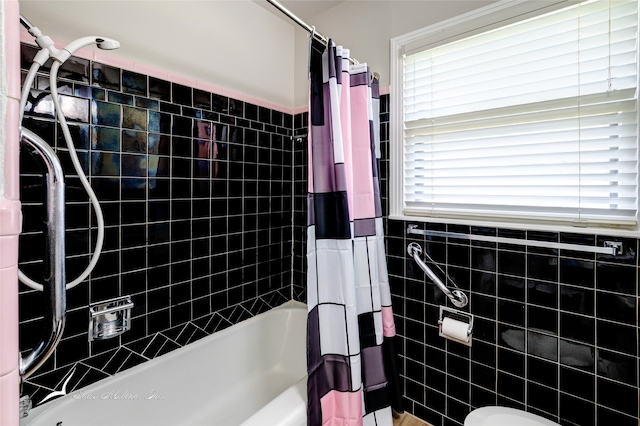 bathroom with shower / bath combo with shower curtain