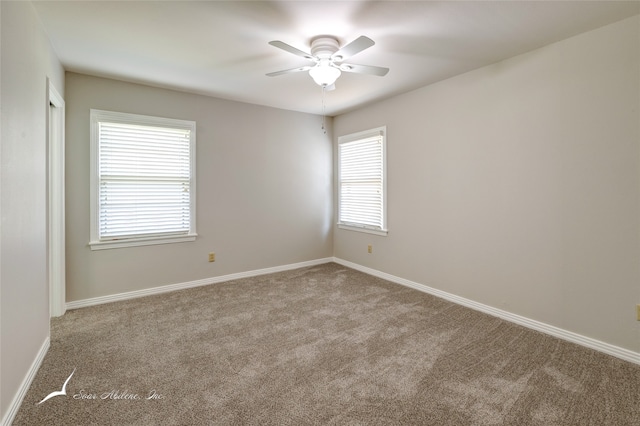 empty room featuring ceiling fan and light carpet