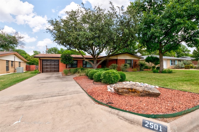 ranch-style home featuring a garage, central air condition unit, and a front lawn