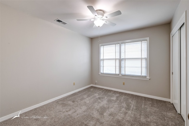 unfurnished bedroom with ceiling fan and light carpet