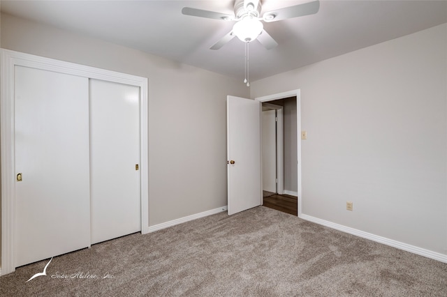 unfurnished bedroom featuring ceiling fan, light carpet, and a closet