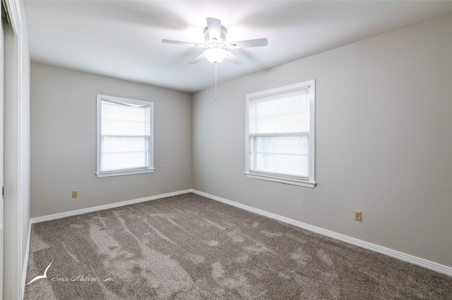 spare room featuring carpet and ceiling fan