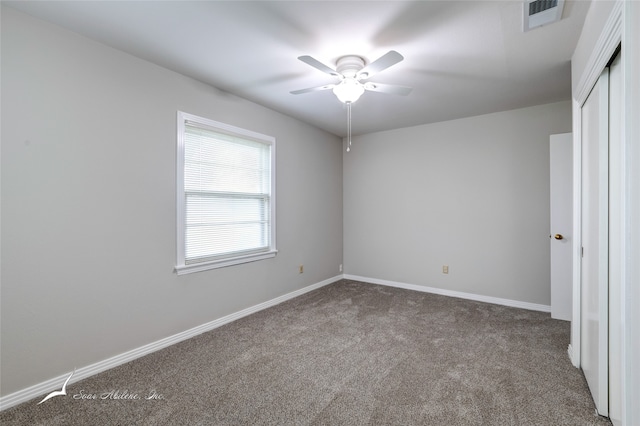 spare room featuring carpet floors and ceiling fan