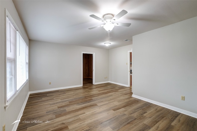 spare room with ceiling fan and wood-type flooring