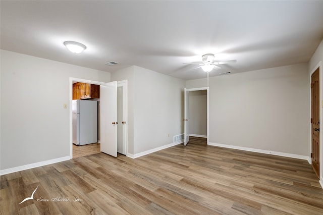 spare room featuring ceiling fan and light hardwood / wood-style flooring