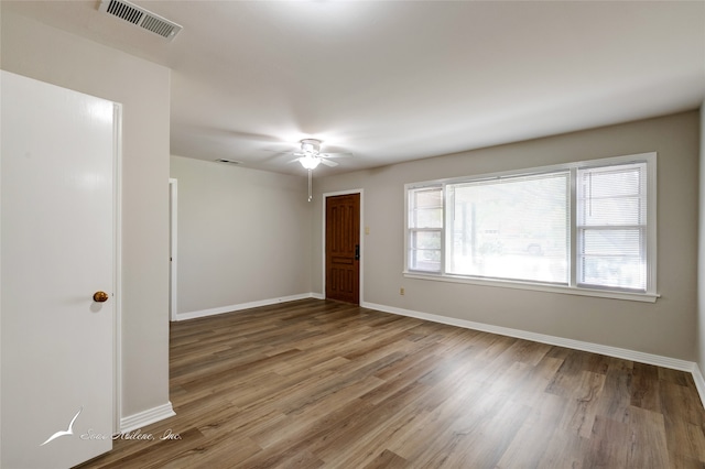 empty room featuring hardwood / wood-style floors and ceiling fan