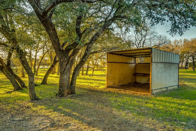 view of outbuilding with a yard