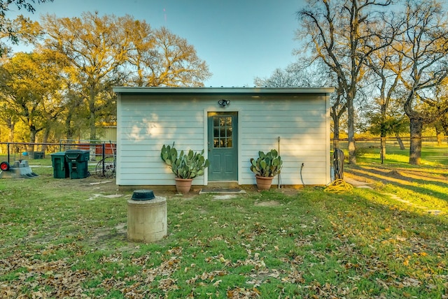 view of outdoor structure featuring a lawn