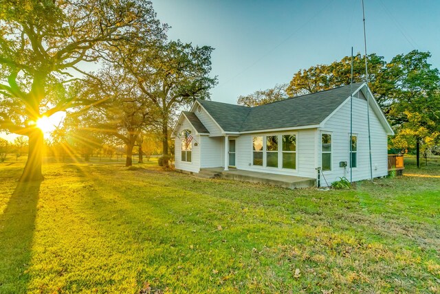 view of side of property with a yard