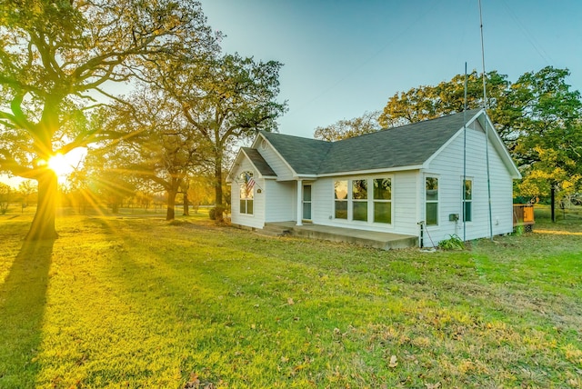 view of side of property featuring a yard