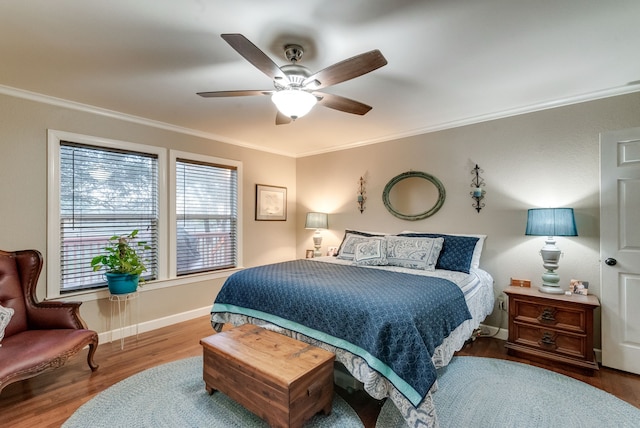 bedroom with ceiling fan, crown molding, and hardwood / wood-style flooring