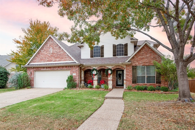 view of front of house with a garage and a yard