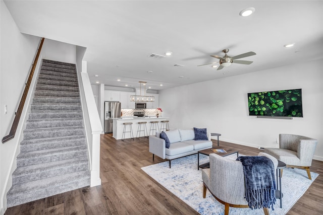 living room featuring dark hardwood / wood-style floors and ceiling fan