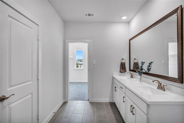 bathroom with tile patterned flooring and vanity