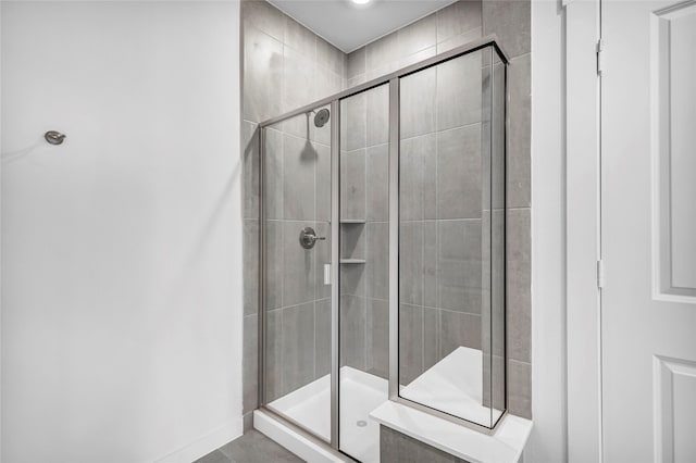 bathroom with a shower with door