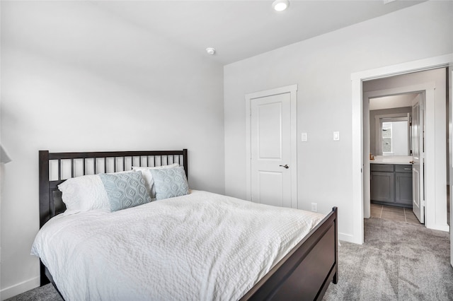 carpeted bedroom with ensuite bathroom