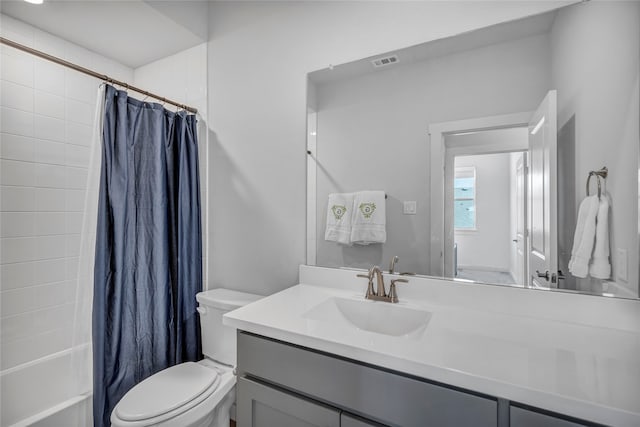 full bathroom featuring shower / bath combination with curtain, vanity, and toilet