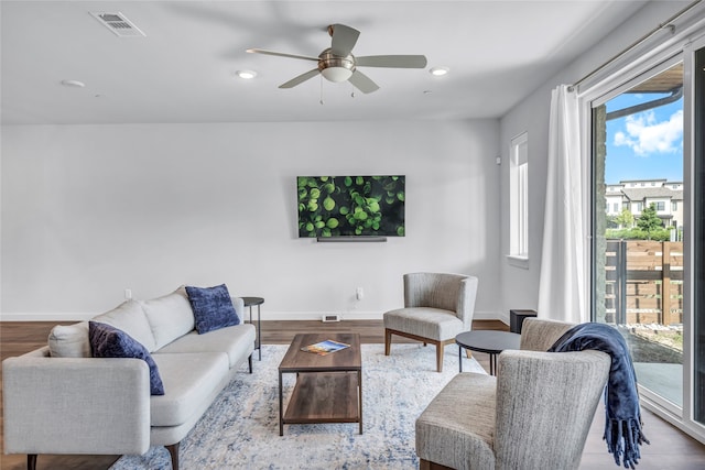 living room featuring ceiling fan and hardwood / wood-style floors