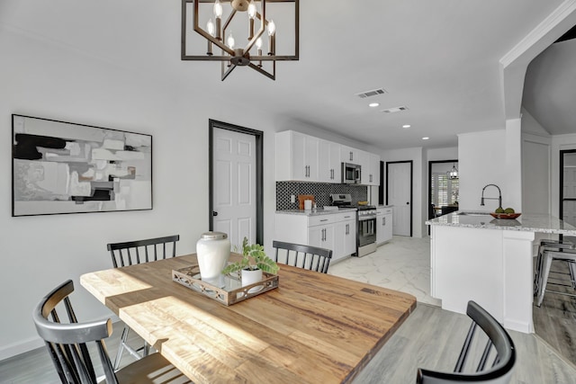 dining room featuring an inviting chandelier and sink