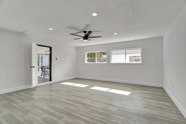 empty room with light wood-type flooring and ceiling fan