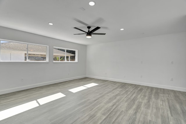 unfurnished room with ceiling fan and light wood-type flooring