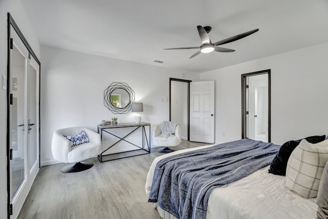 bedroom with ceiling fan and light hardwood / wood-style floors