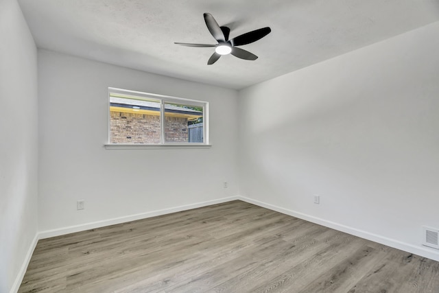 empty room featuring ceiling fan and light wood-type flooring