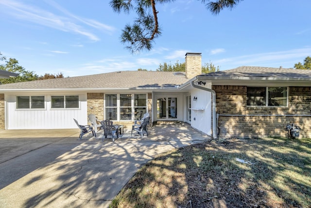 rear view of property with french doors and a patio