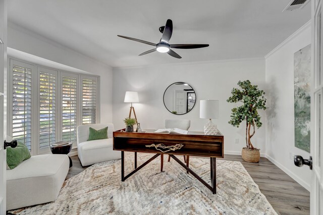 home office featuring hardwood / wood-style floors, ceiling fan, and ornamental molding