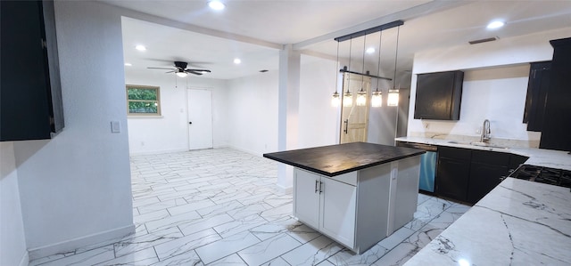 kitchen with a center island, sink, hanging light fixtures, stainless steel dishwasher, and ceiling fan