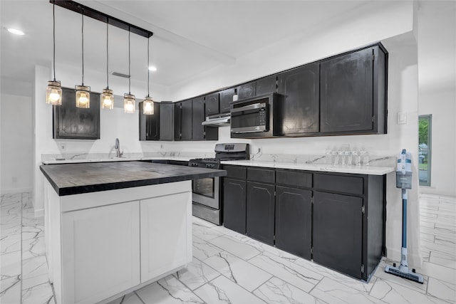 kitchen featuring sink, pendant lighting, and appliances with stainless steel finishes