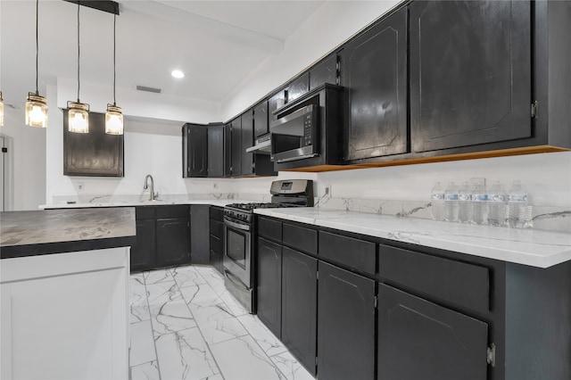 kitchen with hanging light fixtures, stainless steel appliances, and sink